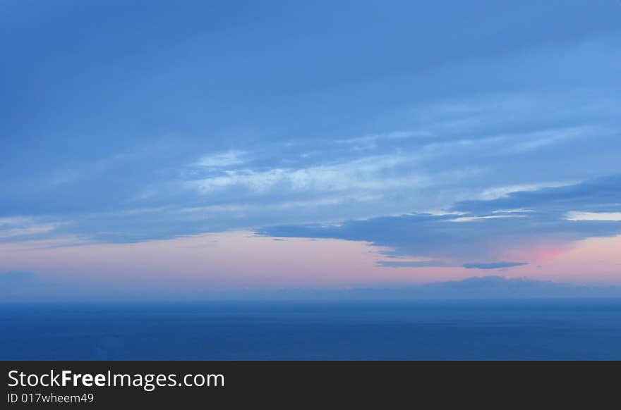 Sunset with large rain clouds above a sea