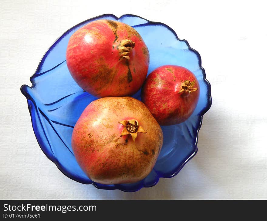 Three fresh pomegranate on table