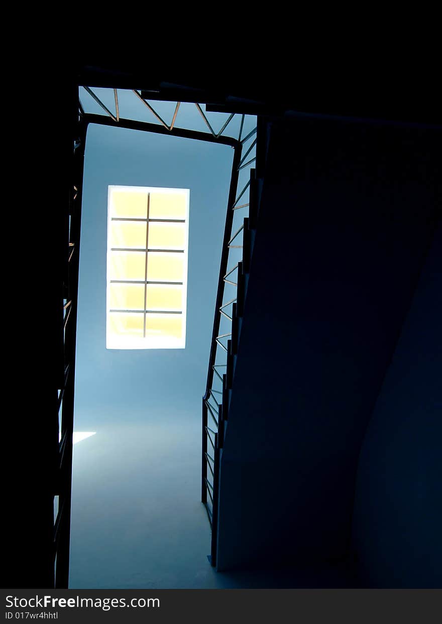 A suggestive shot of a skylight at the top of a staircase
