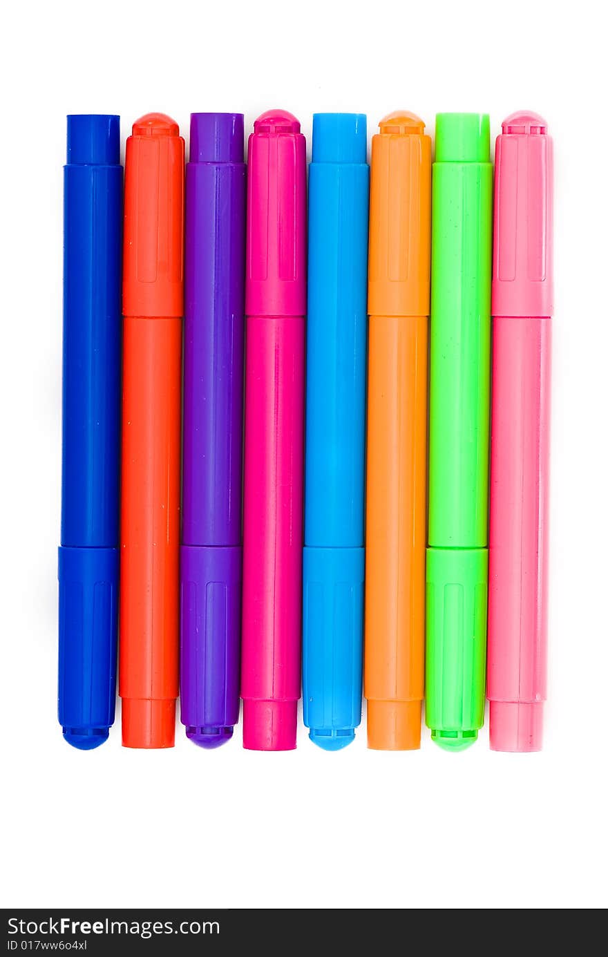 Varicoloured markers on the white isolated background