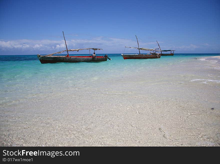 Three sailing boat in blue water