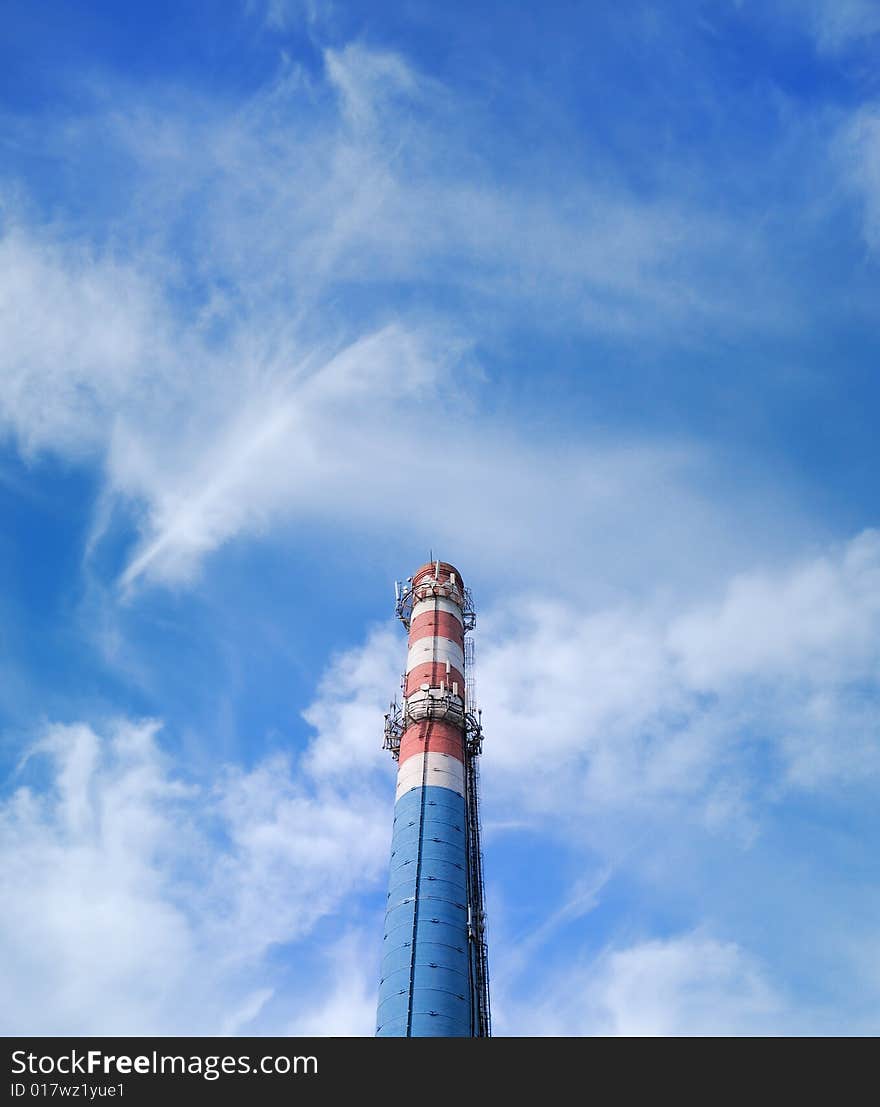 Urban chimney-stalk on a background cloudy sky. Urban chimney-stalk on a background cloudy sky