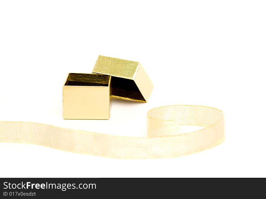 Small gold gift box with the ribbon on white