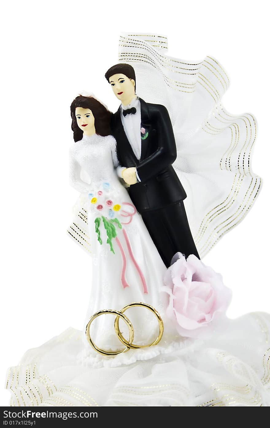 Figures of a newly-married couple isolated on a white background