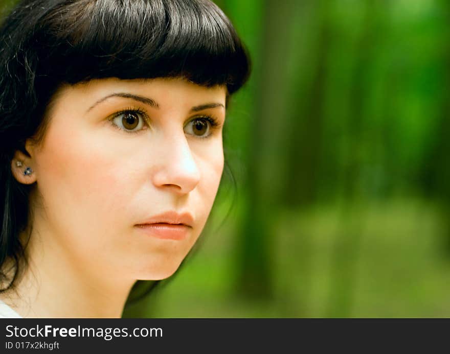 Closeup portrait of scared girl in forest