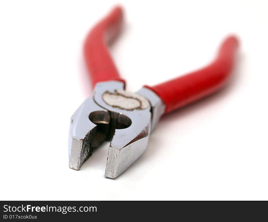 Close-up of dirty and used red pair of pliers isolated on a white background. Close-up of dirty and used red pair of pliers isolated on a white background