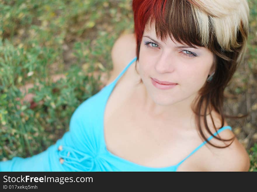 Young beautiful woman lying on the green grass. Young beautiful woman lying on the green grass