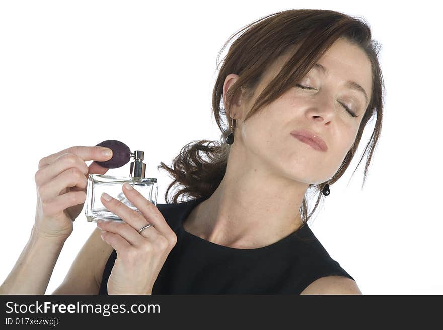 Sensual woman applying perfume on her body