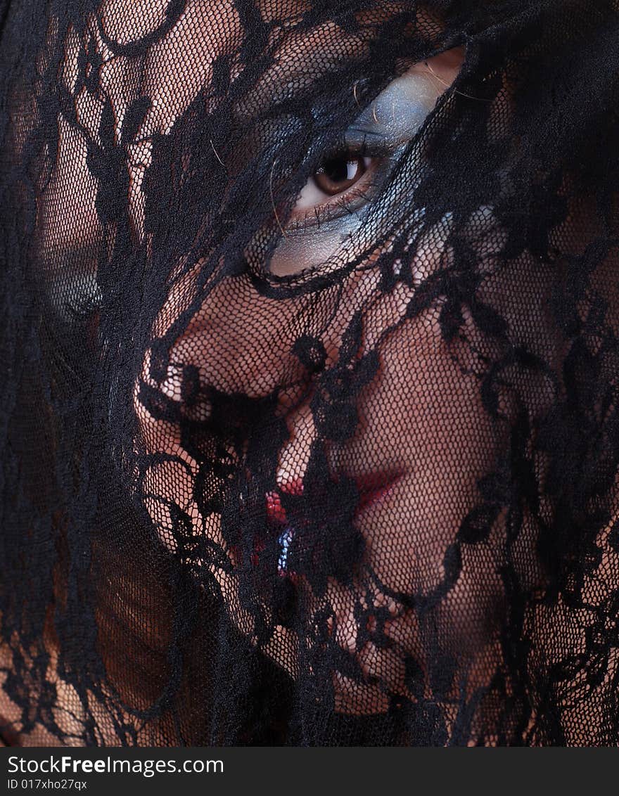 Woman face in a mask of black lace