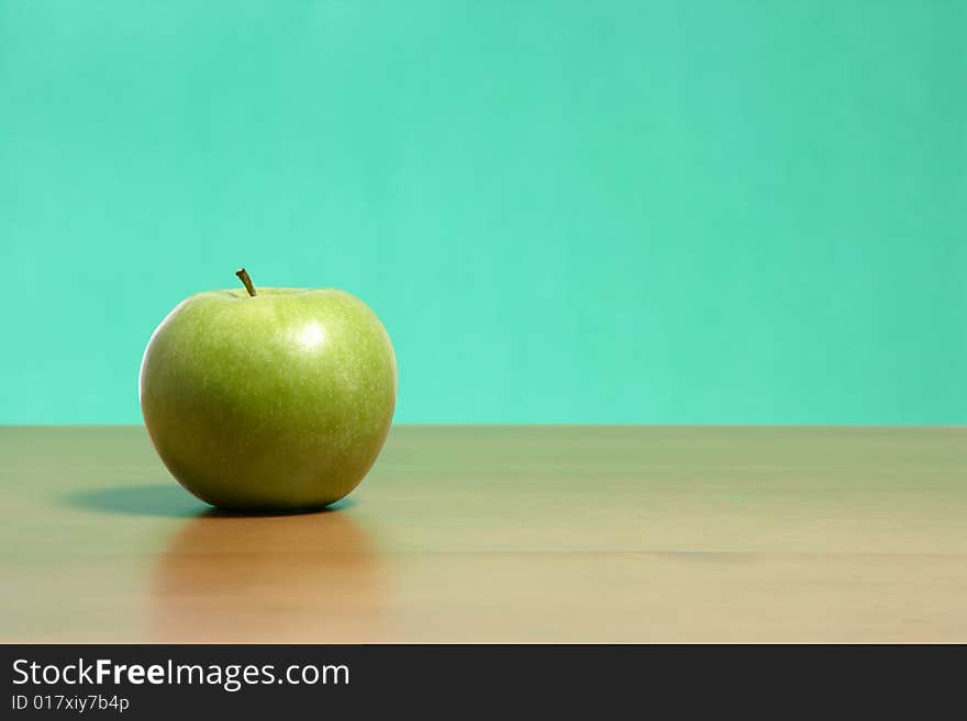 An apple on a desk in the classroom