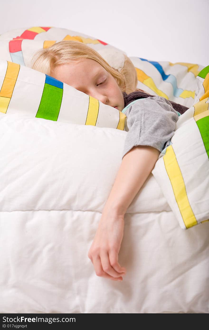 Sleeping young cute child in a colorful bed. Sleeping young cute child in a colorful bed