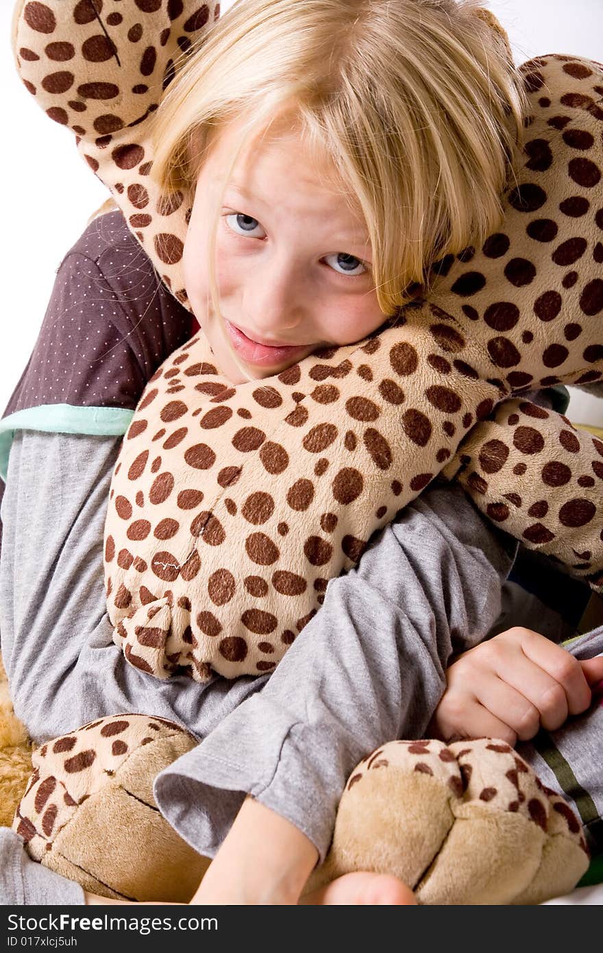 Happy blond girl hugging with her toy. Happy blond girl hugging with her toy