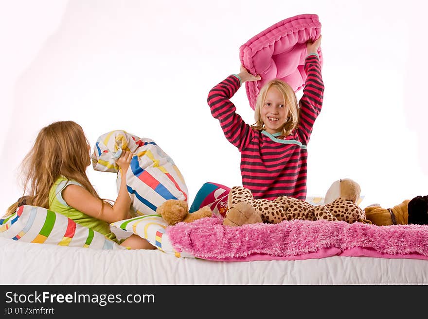 Two young children enjoying their colorful bed. Two young children enjoying their colorful bed