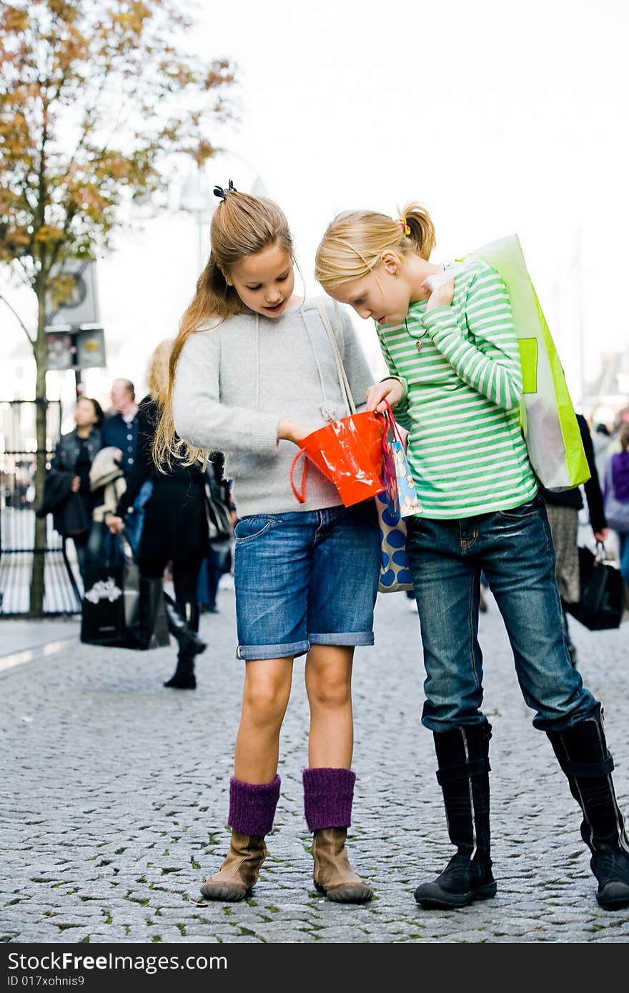 Two young children hanging around the streets while shopping. Two young children hanging around the streets while shopping