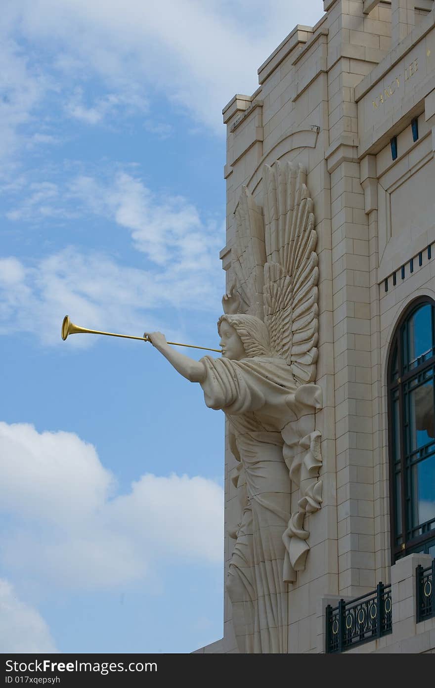 An image of an angel on a building with a horn