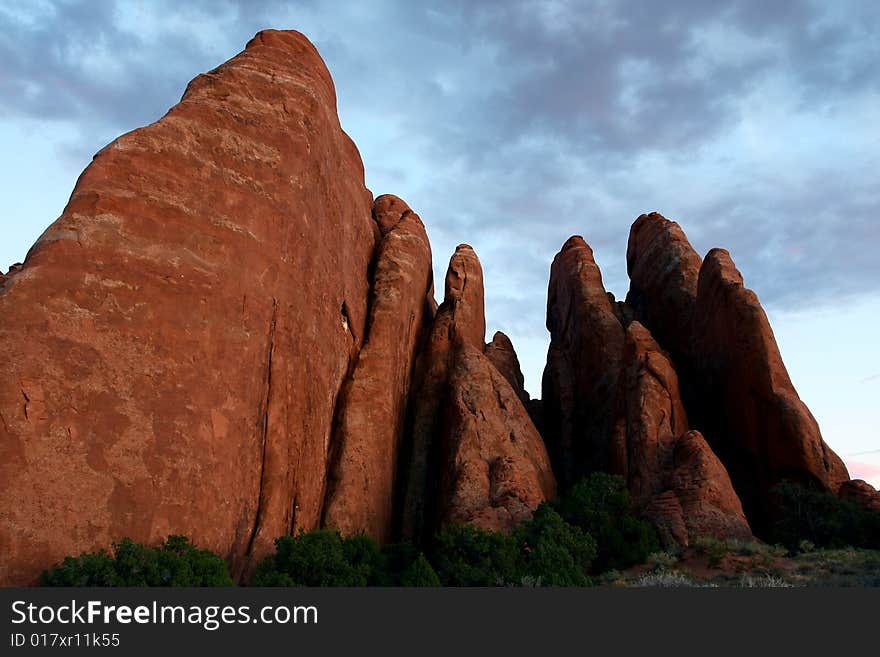 Red rock fin formation at twilight in desert southwest. Red rock fin formation at twilight in desert southwest.