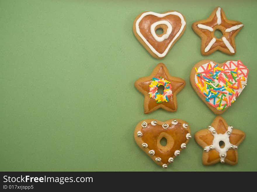 Six decorated gingerbread cookies on green with ad space on left. Six decorated gingerbread cookies on green with ad space on left