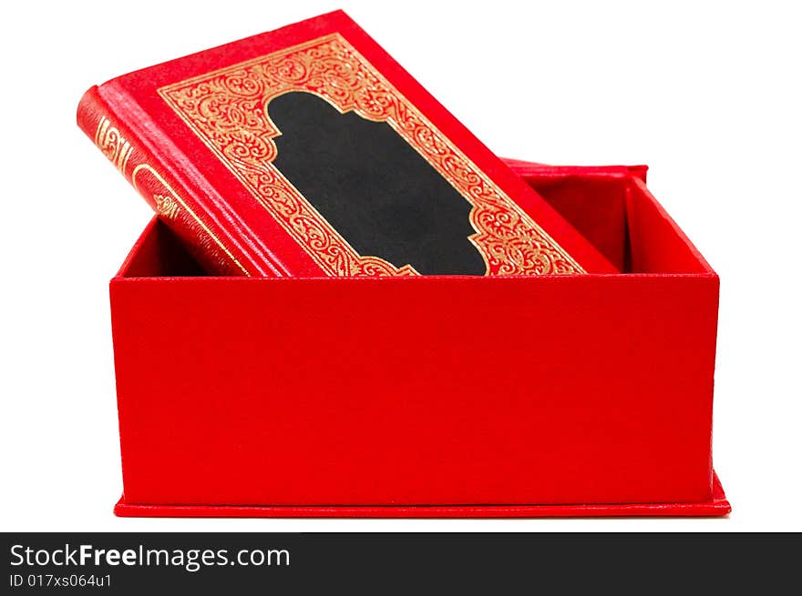 Red cover book with golden decoration (ornament) in red cardboard box on isolated background. Red cover book with golden decoration (ornament) in red cardboard box on isolated background.