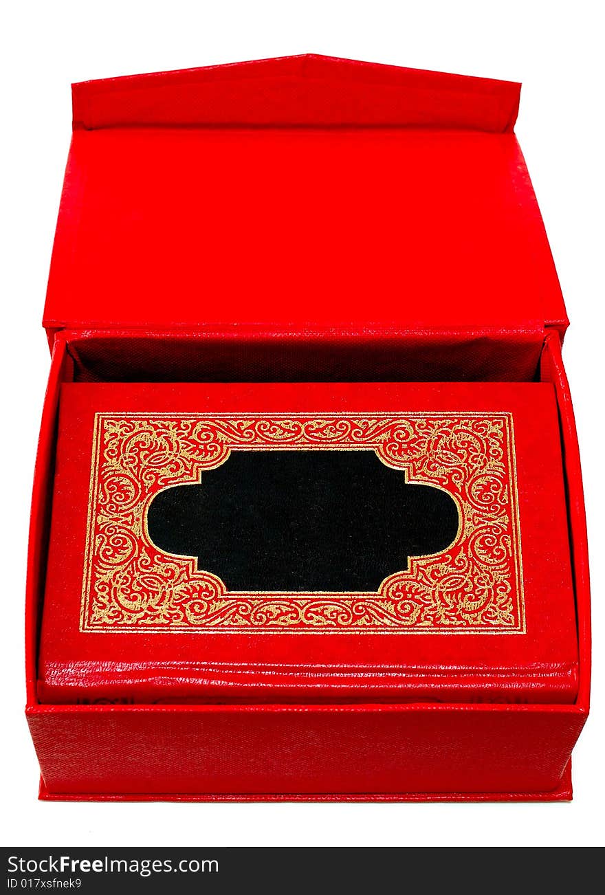 Red cover book with golden ornament in red box.