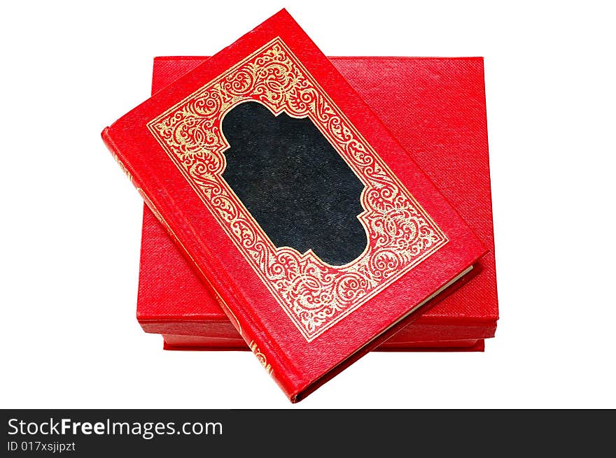 Red cover book with golden ornament in red box.