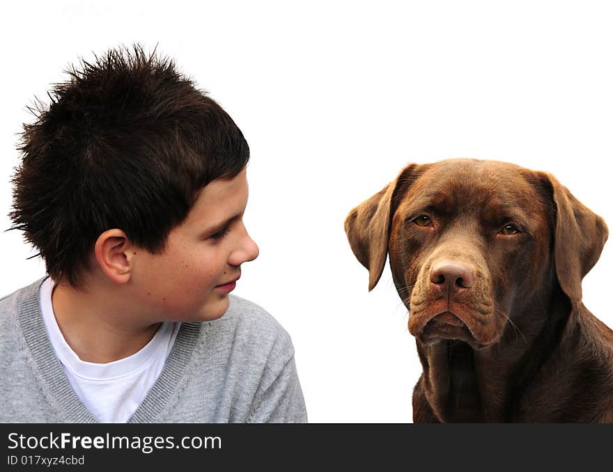 Shot of a boy with his chocolate labrador. Shot of a boy with his chocolate labrador