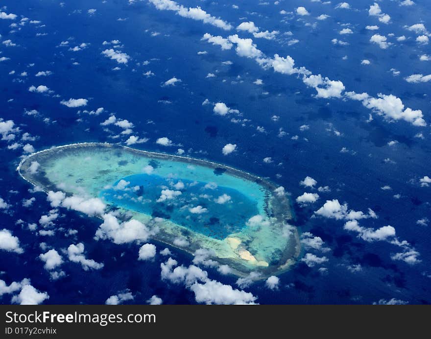 Clouds and coralline island