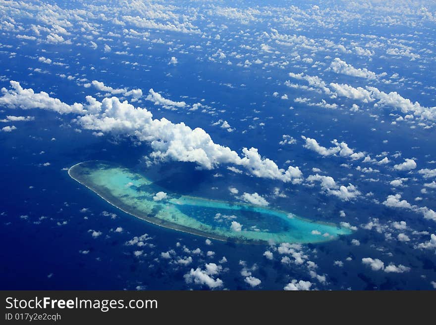 Clouds and coralline island