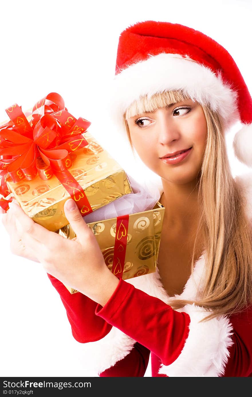 Beautiful interested girl looking into the Christmas present. Beautiful interested girl looking into the Christmas present