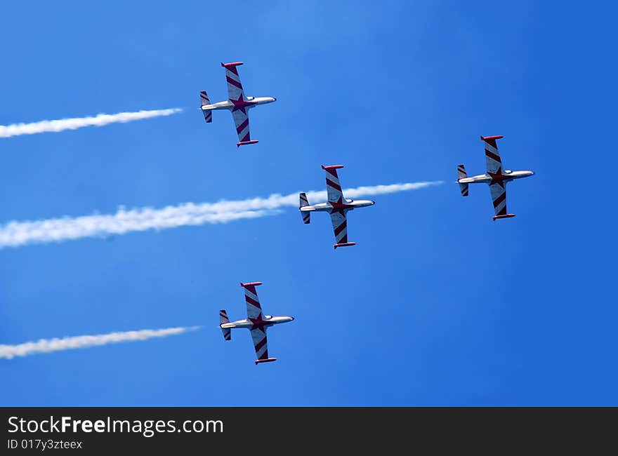 Flying plane formation with smoke trace over blue sky. Flying plane formation with smoke trace over blue sky