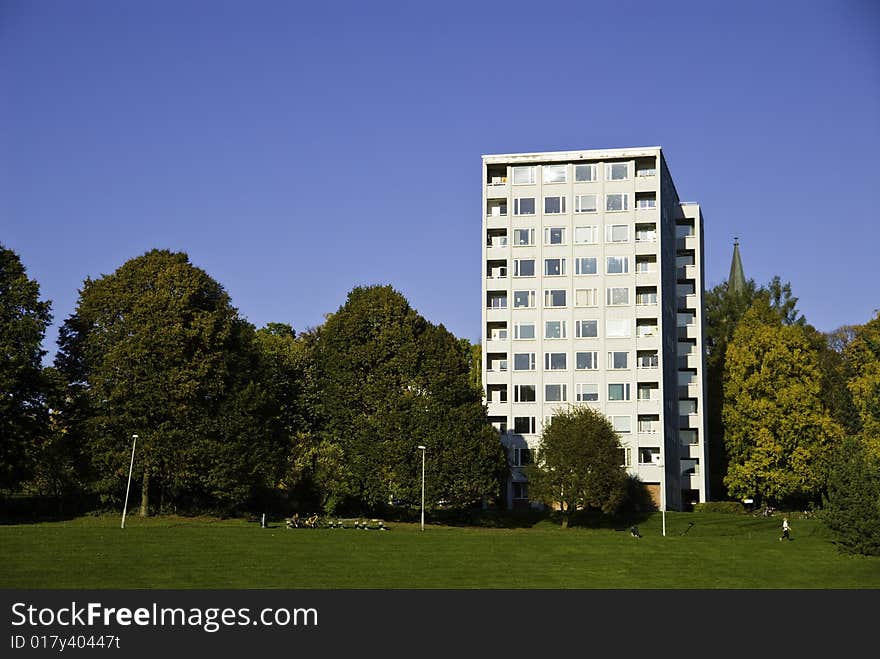 A building next to the park. The trees got color from the atumn. A building next to the park. The trees got color from the atumn.