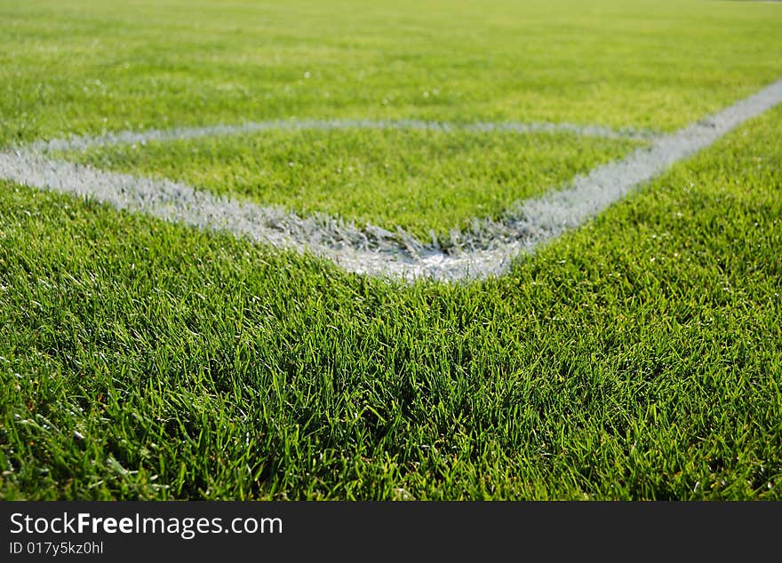 Place for corner kick. Green grass and white line.