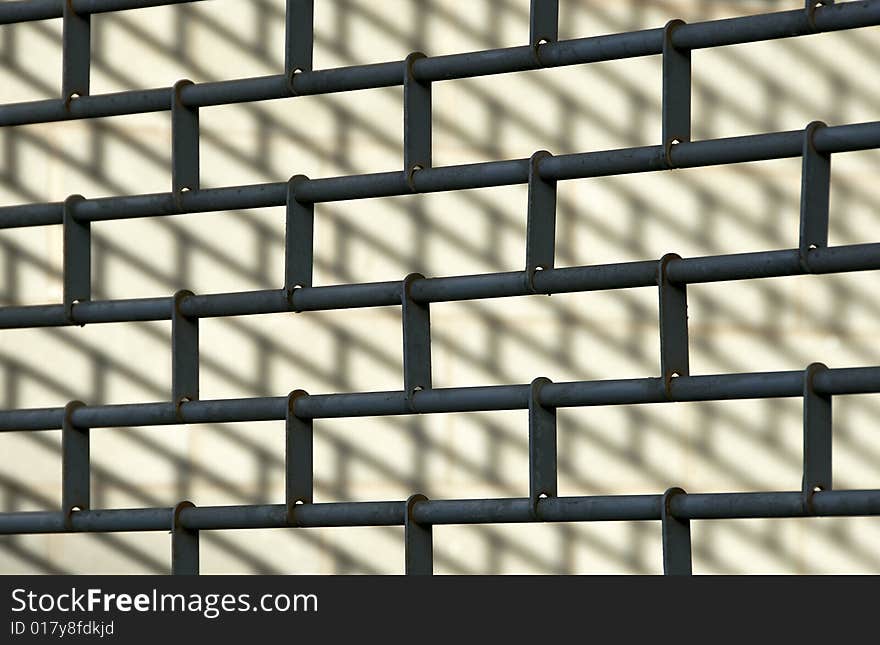 Closeup of a metal shutter with an angled shadow