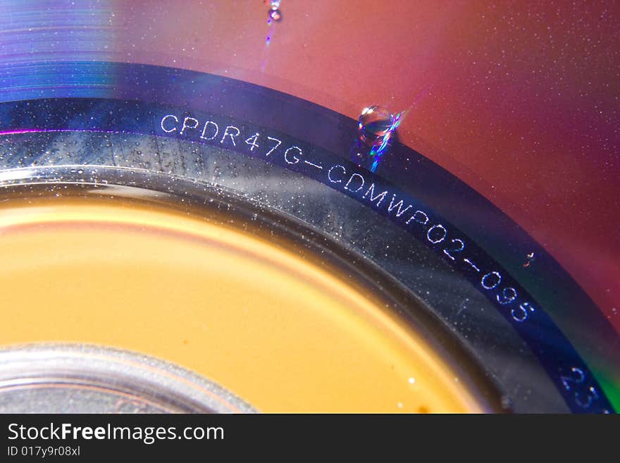 DVD disk with several water droplets on the surface. DVD disk with several water droplets on the surface