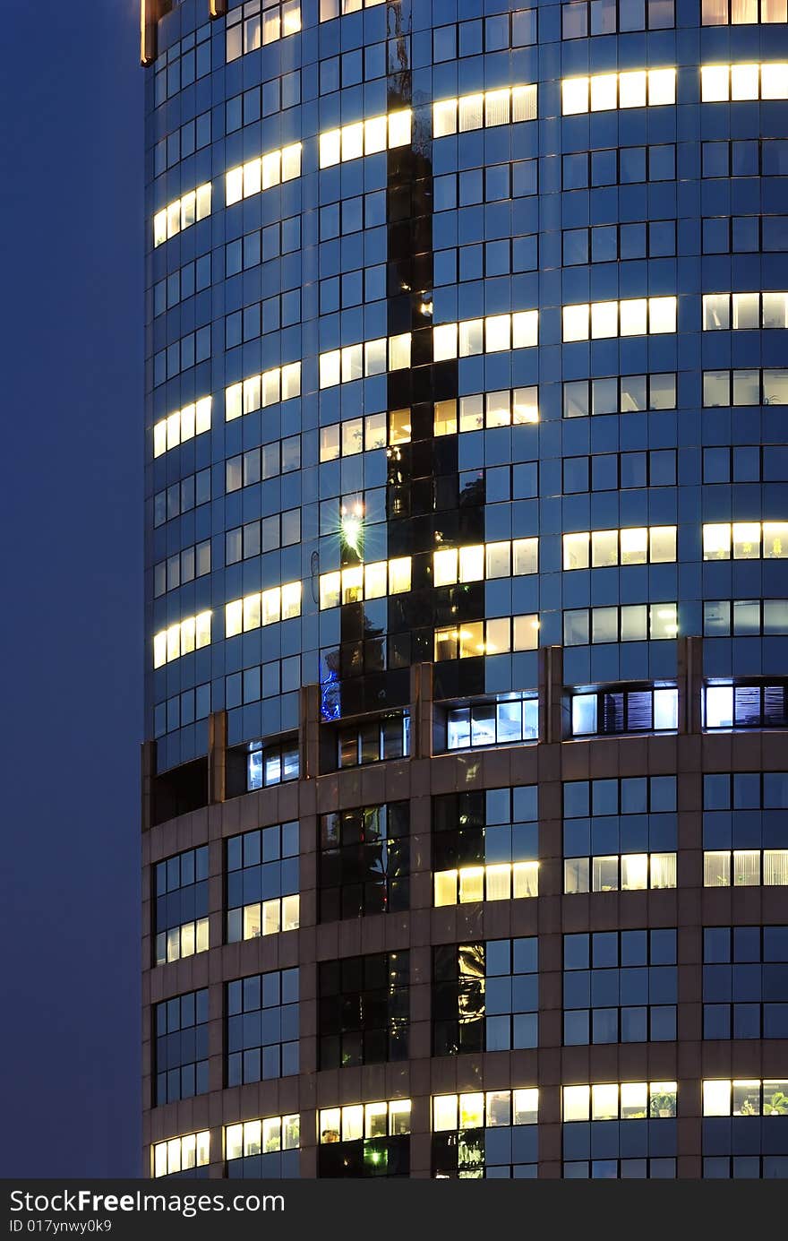 Blue mirrored wall of scyscraper with lights in Moscow (Russia)