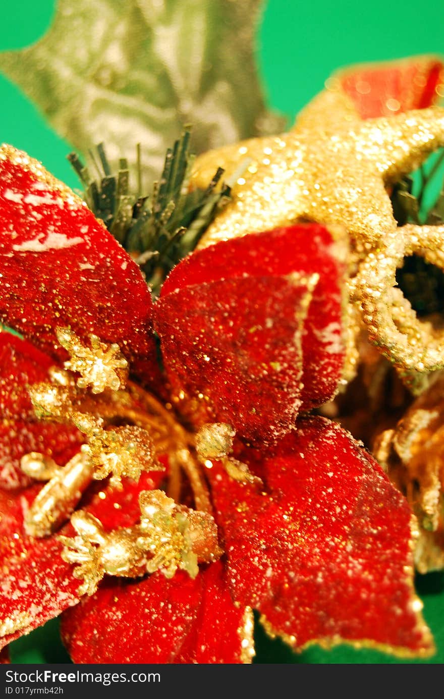 Detail of a christmas decoration with a red flower and a golden star