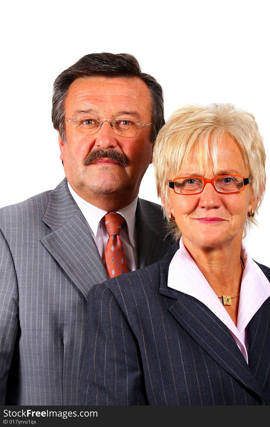 A senior business couple in suits in their 50s and 60s. Isolated over white. A senior business couple in suits in their 50s and 60s. Isolated over white.