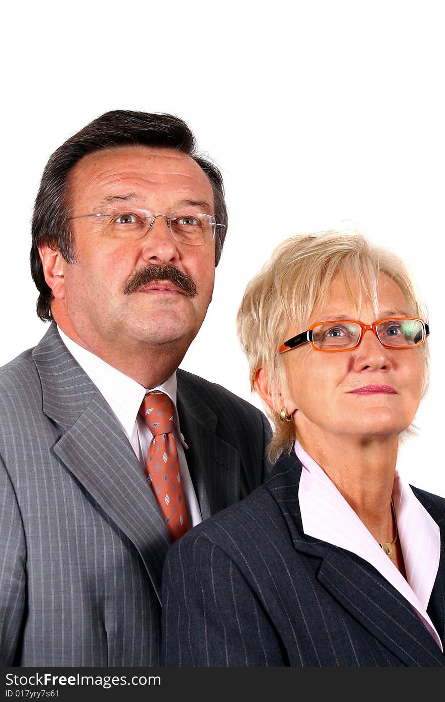 A senior business couple in suits in their 50s and 60s. Isolated over white. A senior business couple in suits in their 50s and 60s. Isolated over white.