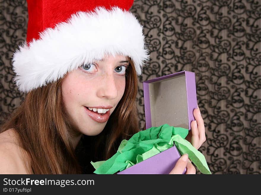 Brunette Teenager wearing a fluffy christmas hat. Brunette Teenager wearing a fluffy christmas hat