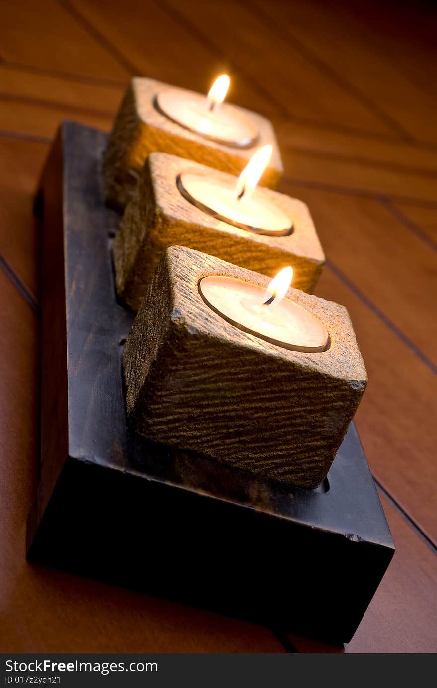 Trio of tea-light candles on a table