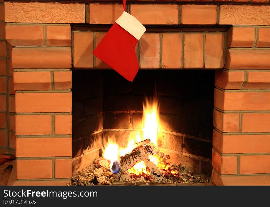 Close-up of brick fireplace with hanging red cristmas sock. Close-up of brick fireplace with hanging red cristmas sock