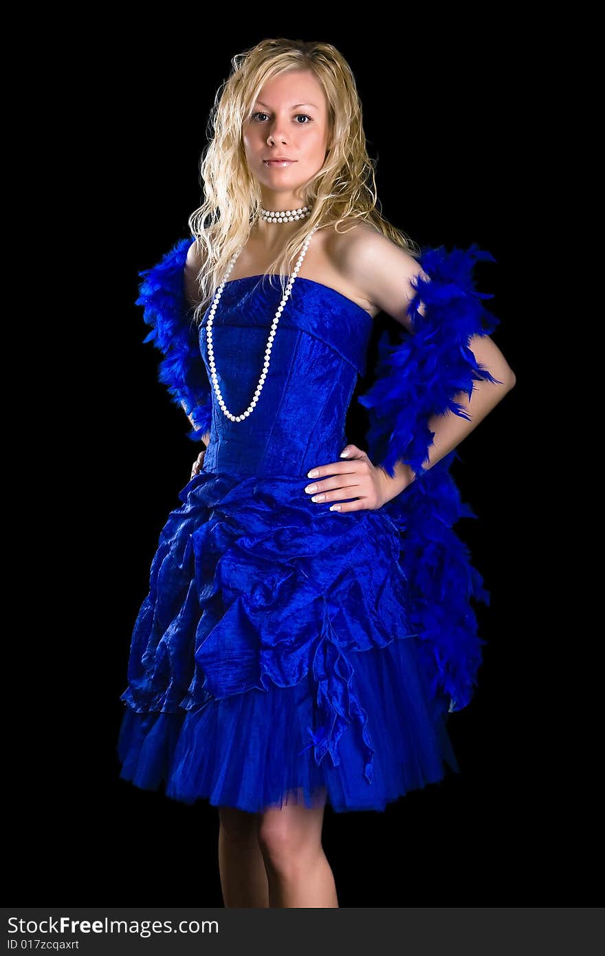 Beautiful girl in a dark blue dress and a pearl necklace on a black background. Beautiful girl in a dark blue dress and a pearl necklace on a black background