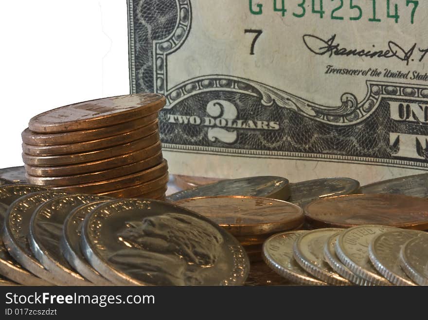 Closeup of two dollar bill with loose change in front