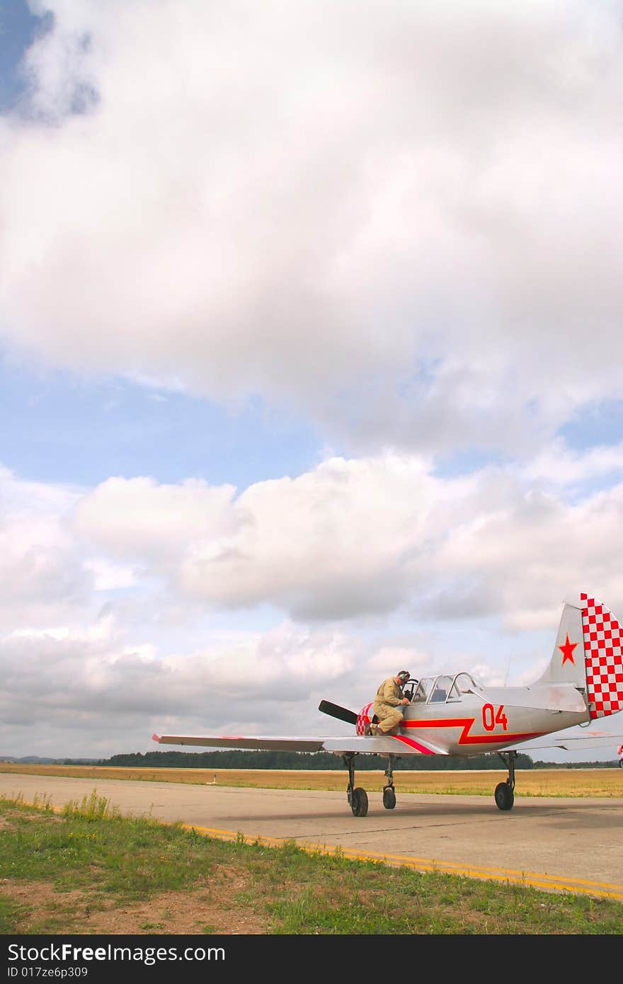 Engineer performing final check on retro airplane before takeoff