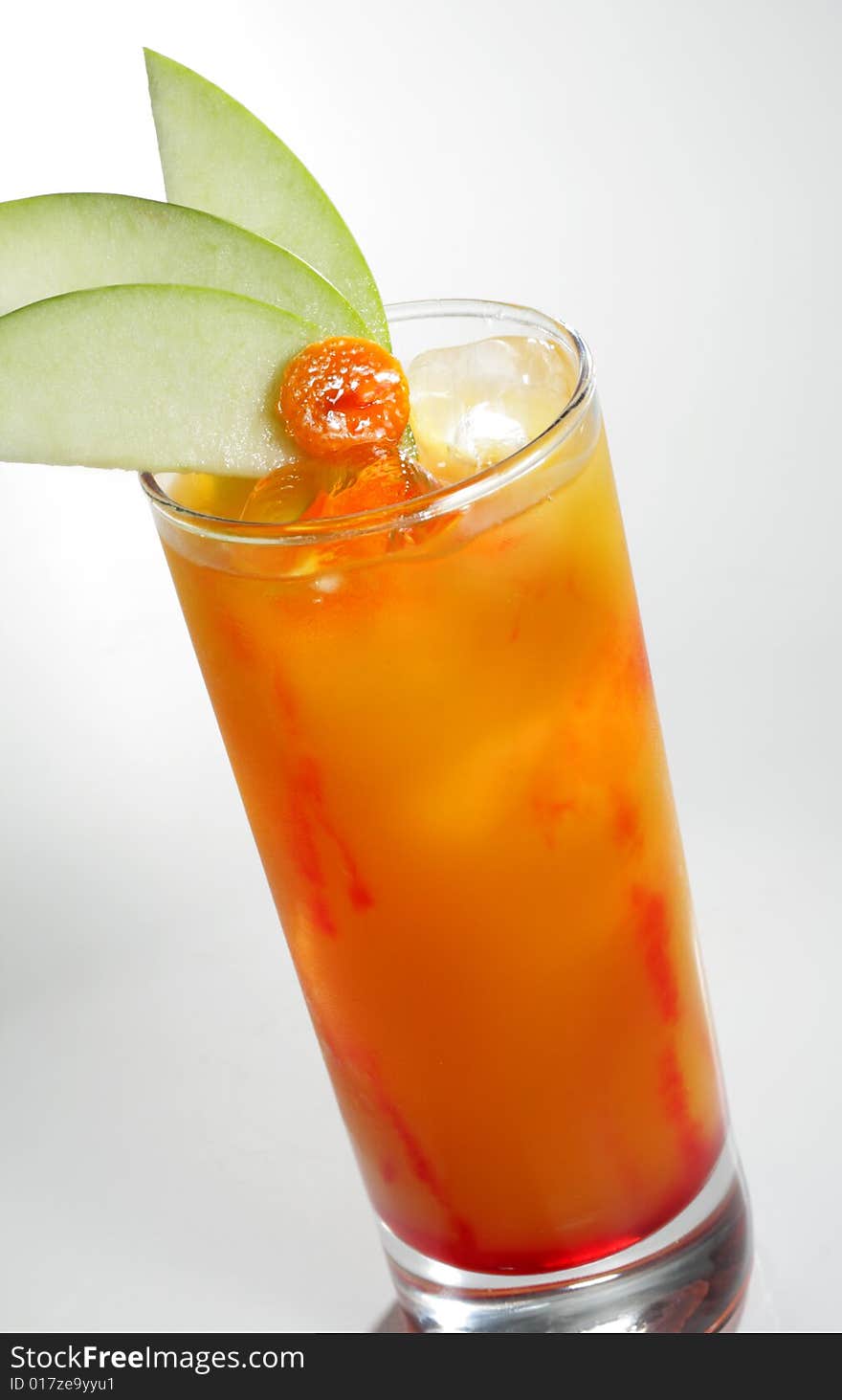 Alcoholic Cocktail made of Liqueur, Rum, Pineapple Juice and Grenadine Syrup Served with Apple Slice. Isolated on White Background. Alcoholic Cocktail made of Liqueur, Rum, Pineapple Juice and Grenadine Syrup Served with Apple Slice. Isolated on White Background