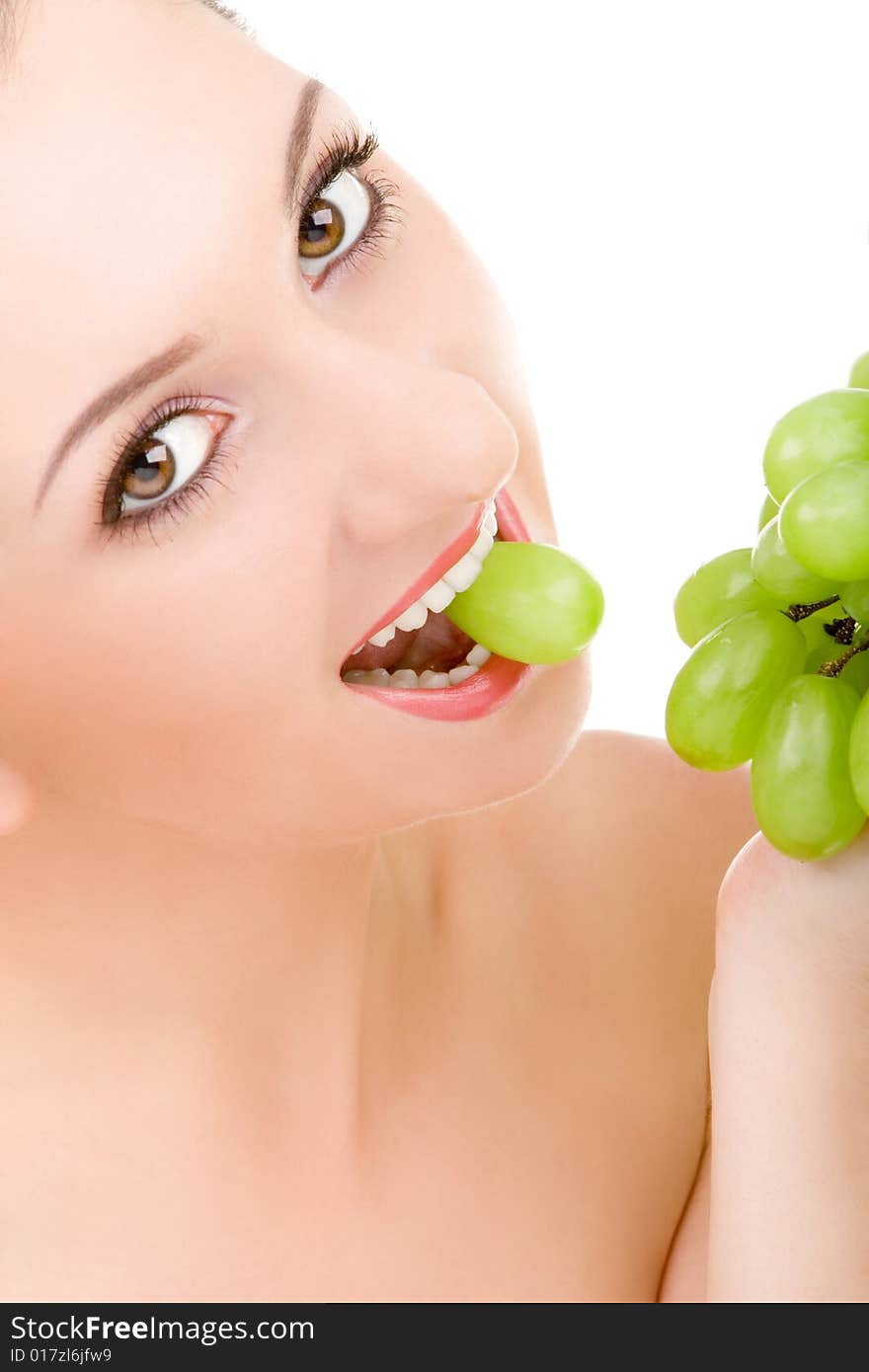 Pretty woman with green grape isolated on the white background