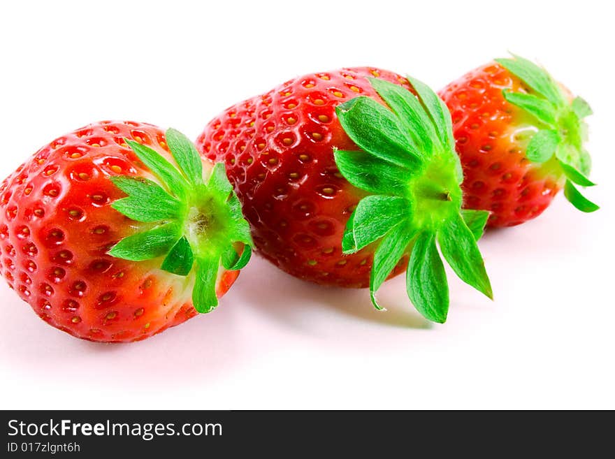 Three strawberries on white background