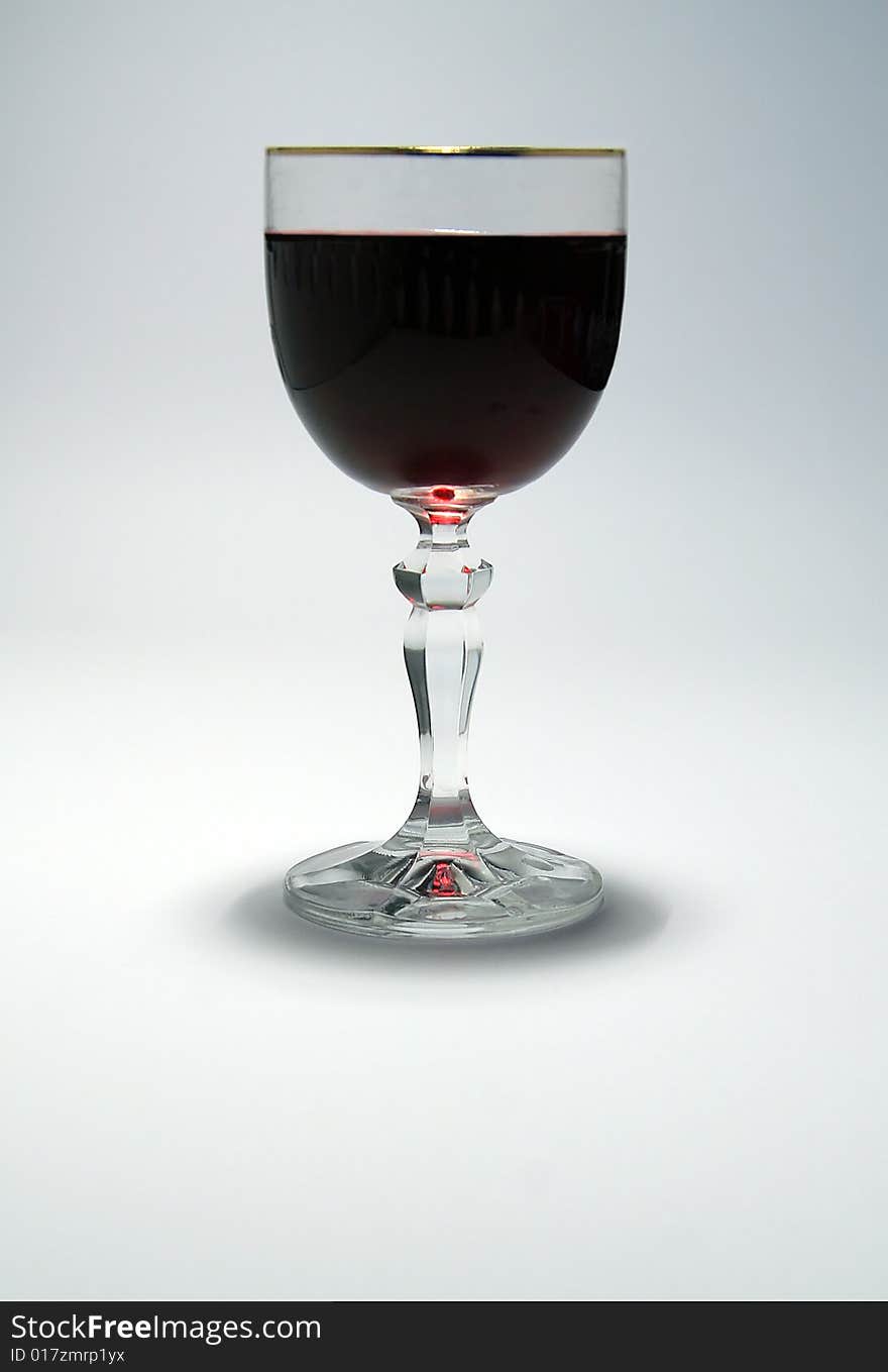 A glass of red wine on white simple background. A glass of red wine on white simple background