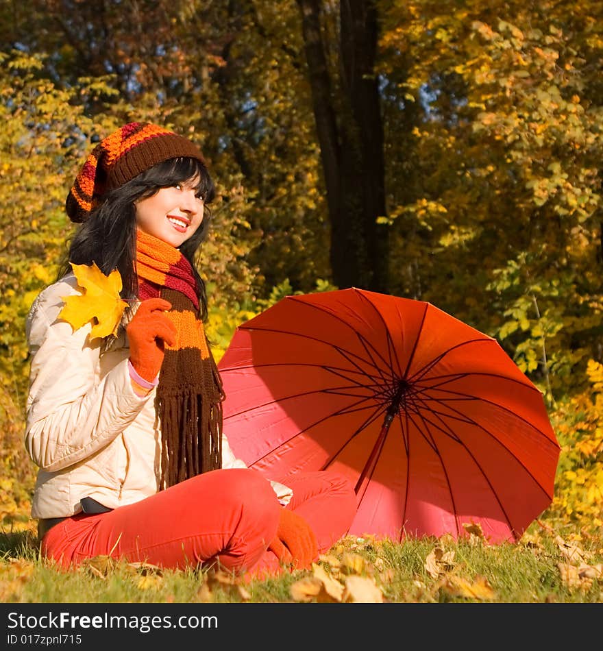 Young woman on the autumn leaf