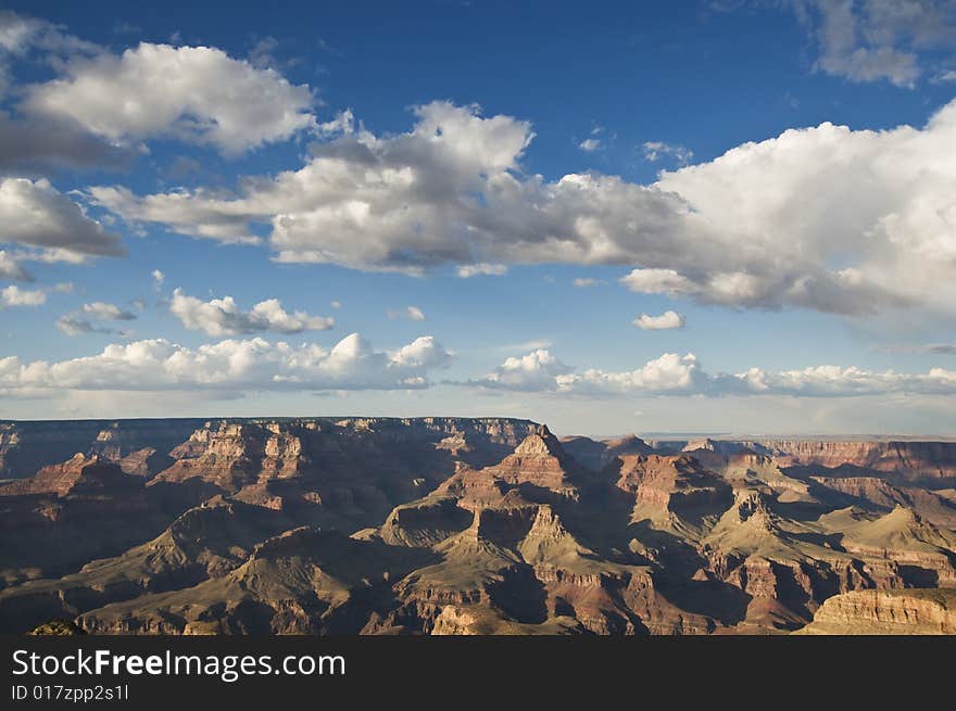 Grand Canyon during the day with a blue sky and clouds