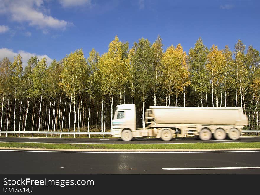 The car for cement transportation moves on road. The car for cement transportation moves on road.